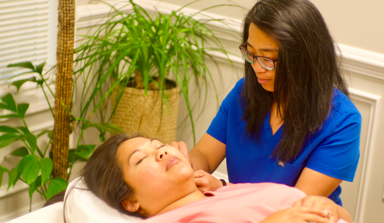 Jacala LAc administering aesthetic facial acupuncture.