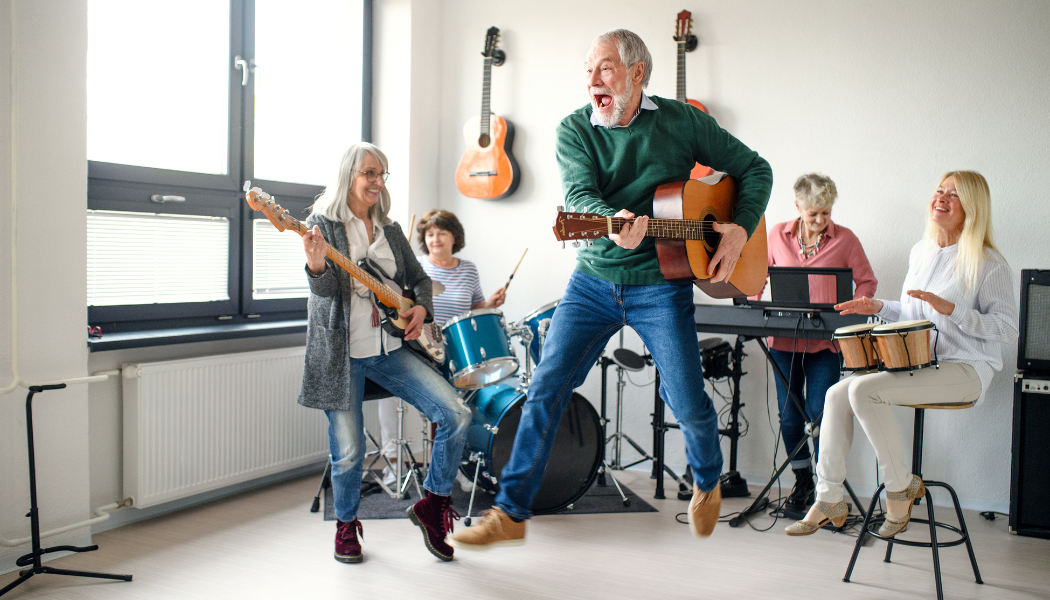 Seniors playing and jumping in a music band.